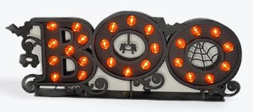 Halloween-themed 'BOO' sign with orange lights.