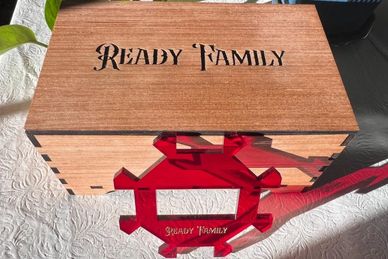 Wooden box and puzzle piece with "Ready Family" engraving.