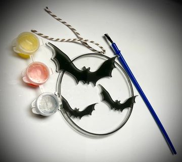 Halloween bats suncatcher shown with three glazes and a brush