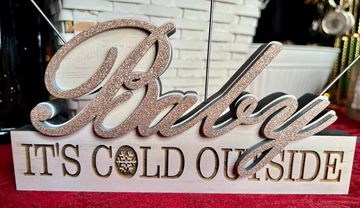 Solid wood 3D "Baby" written in cursive on top of "It's Cold Outside". Holds three photos.