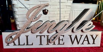 Solid wood photo holder with 3D cursive "Jingle" over top the words ALL THE WAY. Holds three photos.