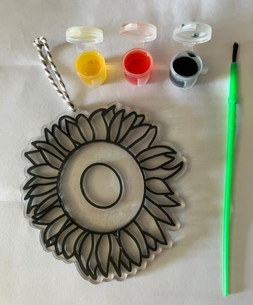 Sunflower suncatcher shown with three glazes and a brush