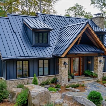 Modern house with dark blue metal roof and stone exterior.