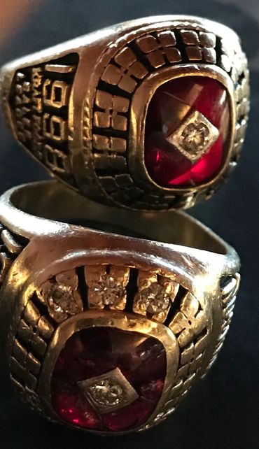 Two ornate rings with red stones and diamond accents.