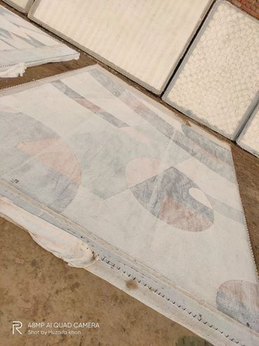 Hand tufted rug being dried out in sun after applying latex on the back