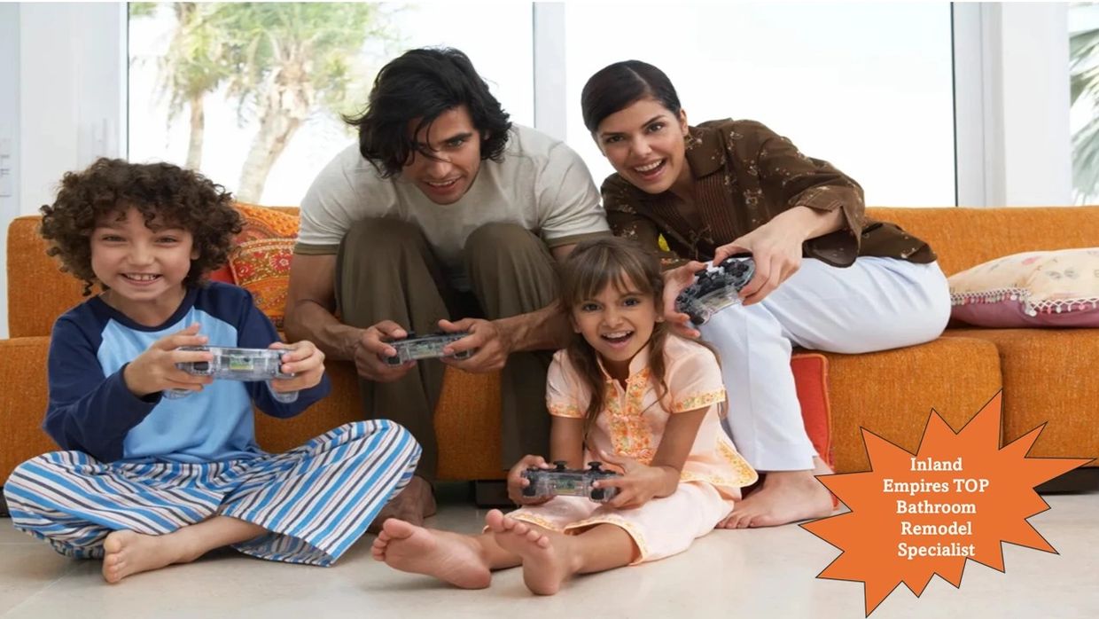 Family of four happily playing video games together in a cozy living room.