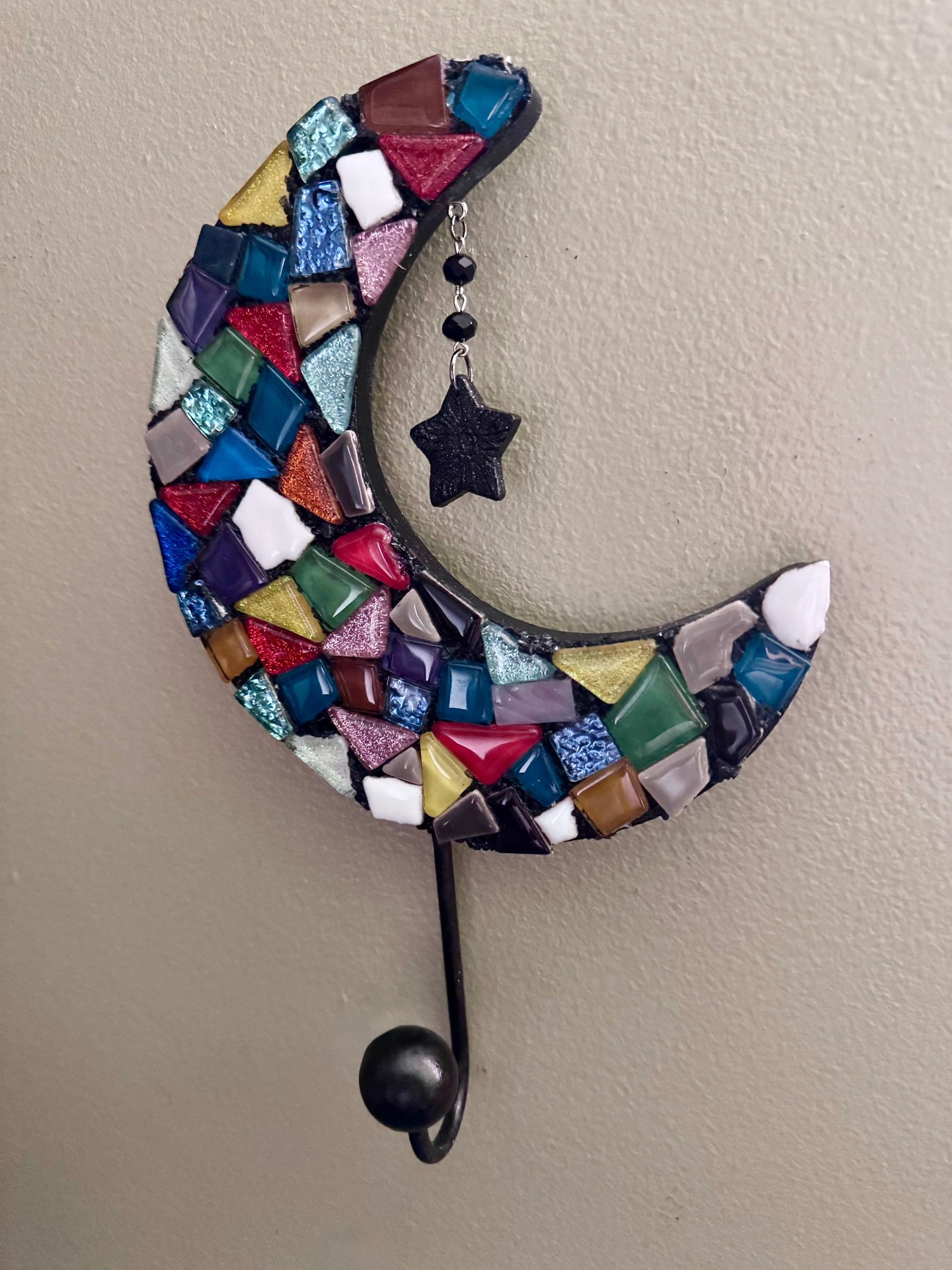 Colorful mosaic crescent moon wall hook with a dangling star ornament.