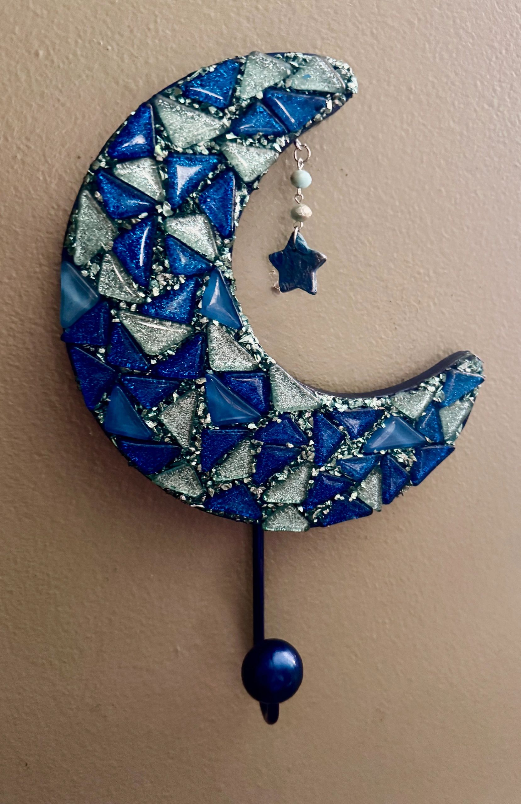 Blue crescent moon mosaic wall decor with dangling star and bead.