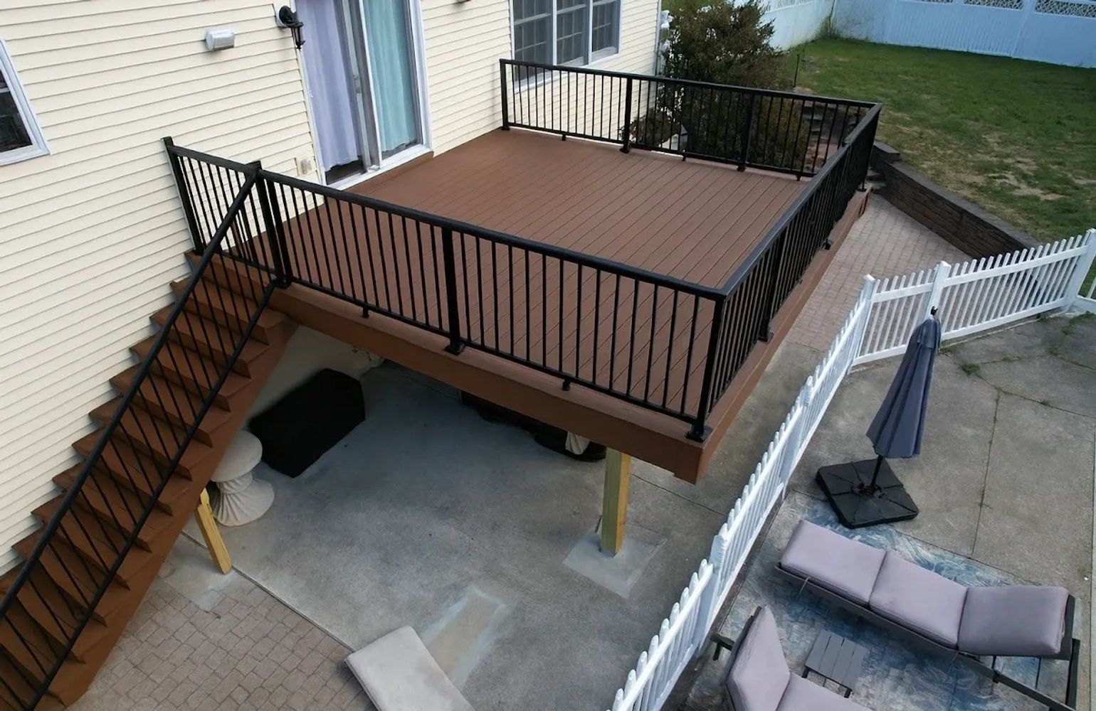 Stack of books next to pencils in a holder and a camera.