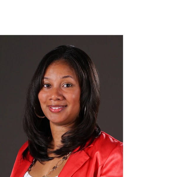 Professional woman in red blazer smiling.