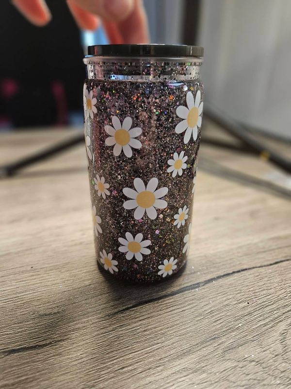 Daisy snow globe cup with black and silver glitter.