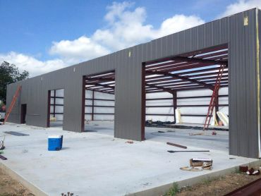 Steel frame building under construction with metal siding.