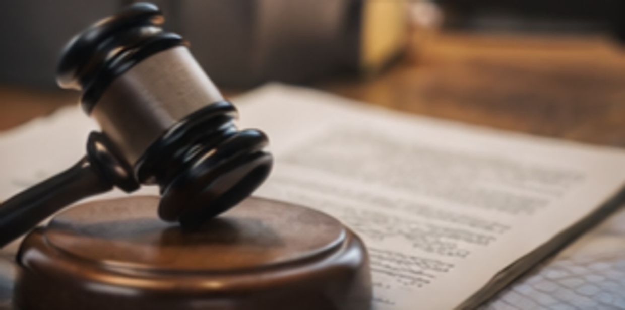 Justice hammer with Paper on the table