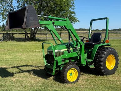 Green John Deere tractor on green grass