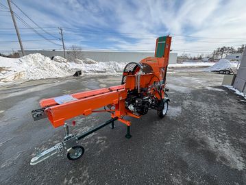 Orange wood chipper machine with conveyor belt on a snowy pavement.