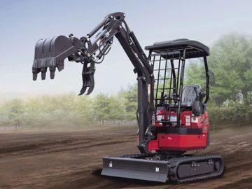 Red XN 2.0 crawler excavator on dirt with trees in background.