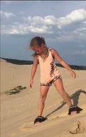 Sand board down the Silver Lake Sand Dunes while renting one of our camper rentals!