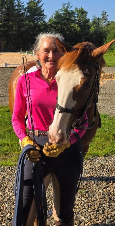 Dressage trainer and riding instructor developing an equestrian partnership with a horse in training.