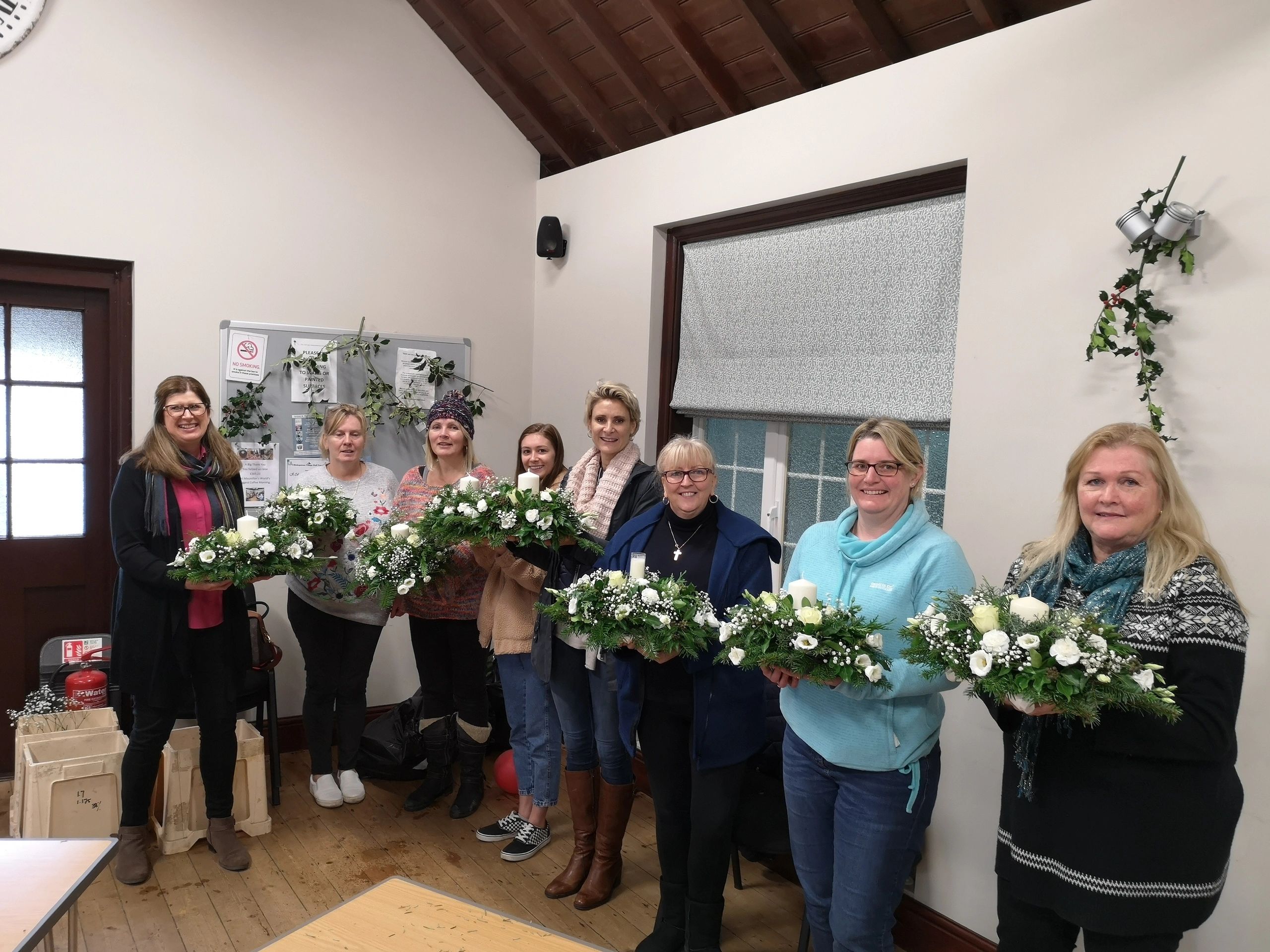 Workshop participants holding their table decorations.