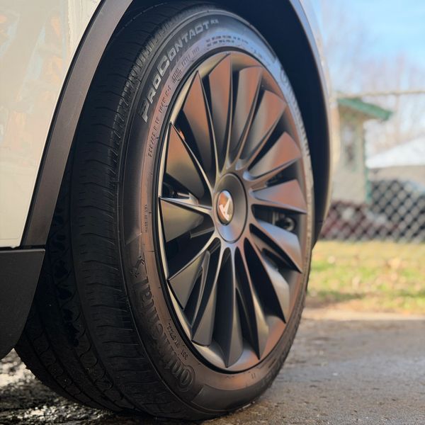 Close-up of a Tesla car wheel and tire.