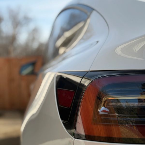 Close-up of a car's rear light at sunset.