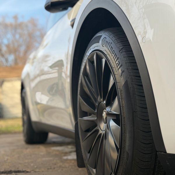 Close-up of a car's Continental tire and wheel.