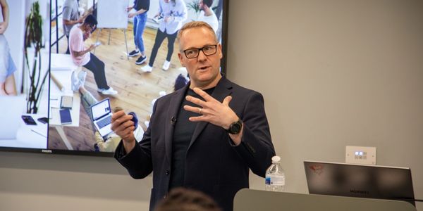 Man giving a presentation in a modern office setting.