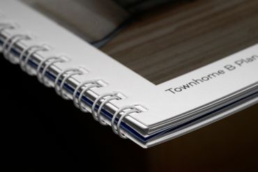 Close-up of a spiral-bound booklet titled 'Townhome B Plan'.
