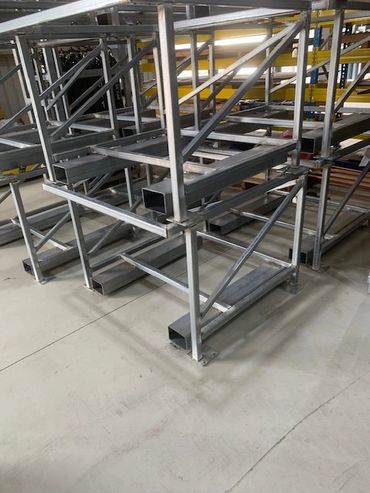 Metal storage racks in an industrial setting.
