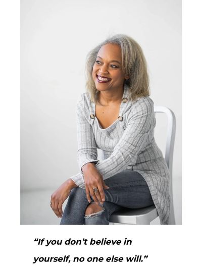 Smiling woman sitting and inspiring with a quote about self-belief.