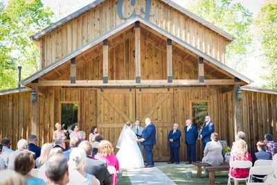 Outdoor wedding ceremony at Charlyn Farms in Marietta, SC, with the bride and groom exchanging vows 