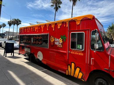 Red food truck with fries and cheese theme.