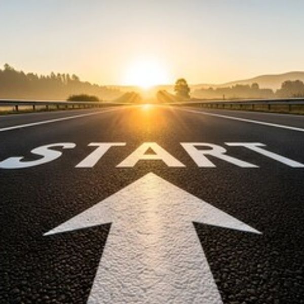 Sunrise on a road with a large START sign and arrow pointing forward.