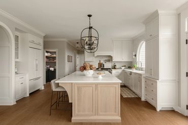 Bright modern kitchen with white cabinetry and a large island.