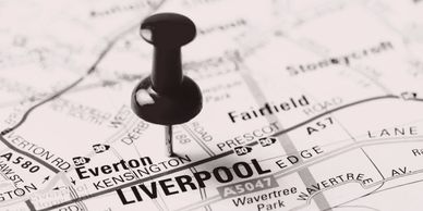 Pushpin marking Liverpool on a black and white map.