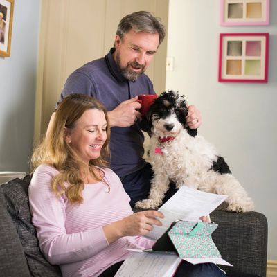 Couple smiling while reviewing insurance claim payment statements
