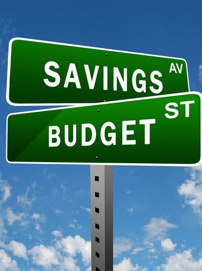 Crossroad sign indicating choices between savings and budgeting
