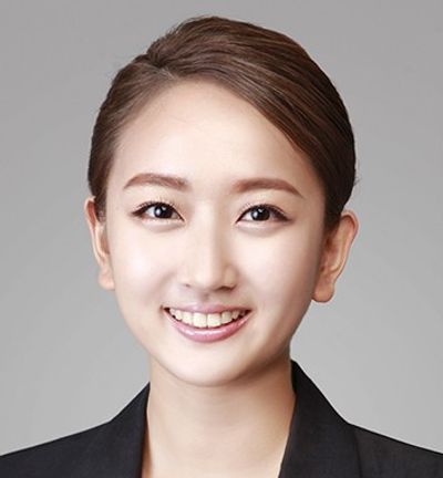 Professional headshot of a smiling woman in business attire.