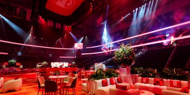 Lavish event setup with dramatic lighting and comfortable seating.