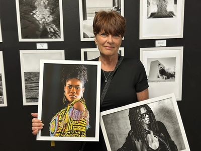 Brigitte Thompson portrait photographer presenting framed portrait prints during SXSW photography ex