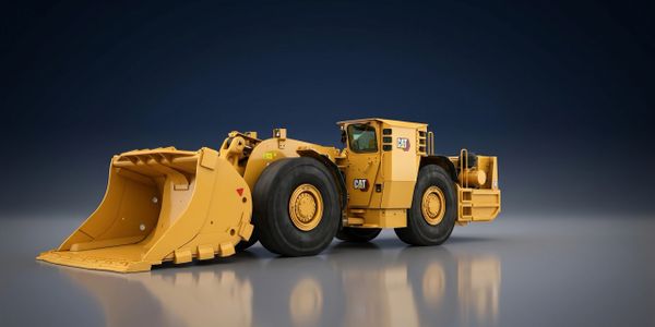 Yellow CAT heavy-duty mining loader with large bucket.