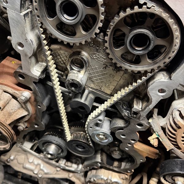Close-up of car engine timing belt and gears.