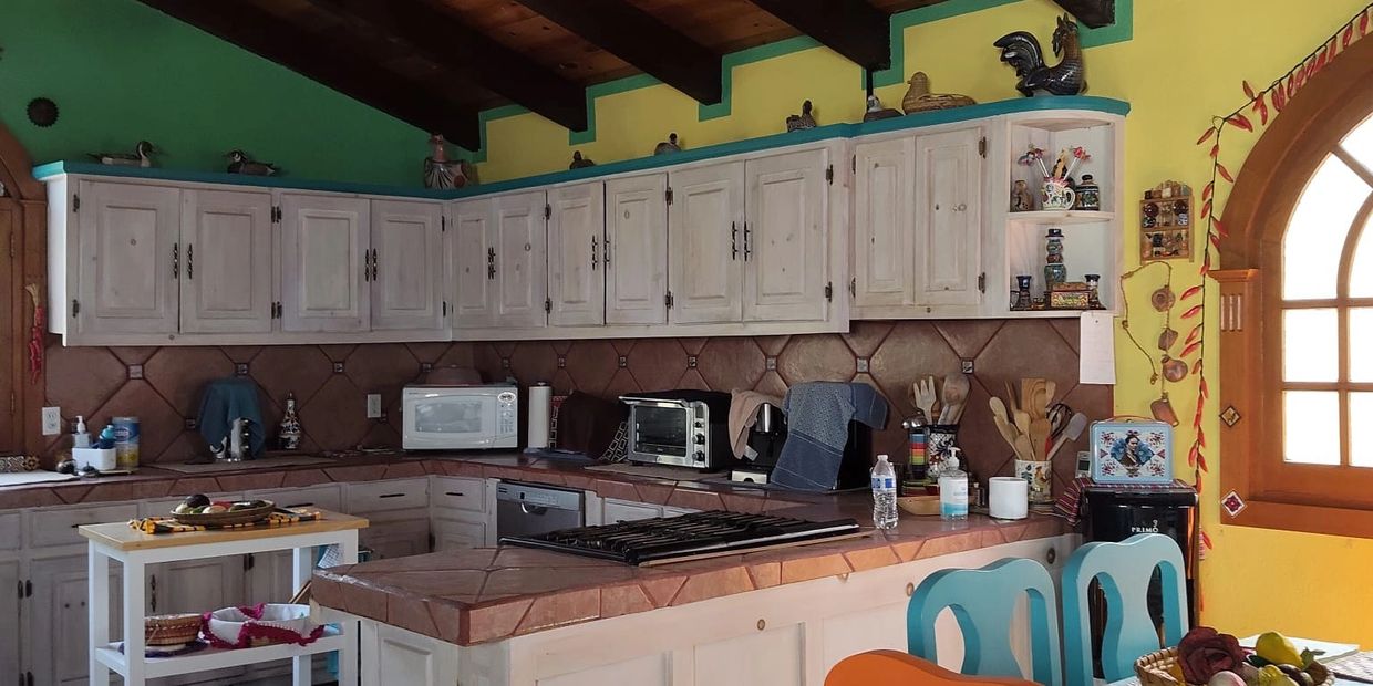 Cozy kitchen with rustic wooden cabinets and colorful walls.