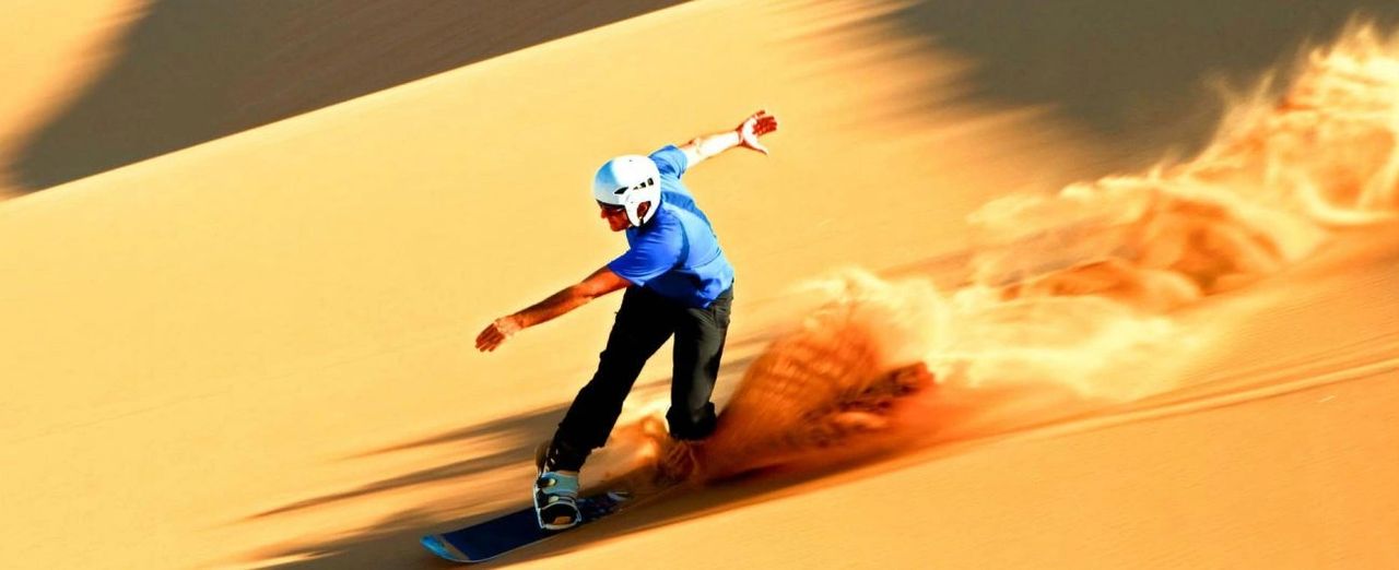 Thrill meets desert vibes - skateboarding across the golden dunes of Dubai's safari adventure.