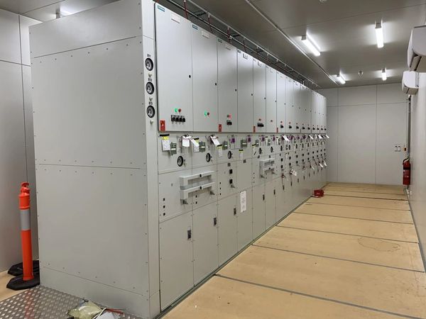 Industrial electrical control panels in a clean, well-lit room.