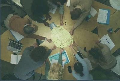 team at work piecing together a puzzle