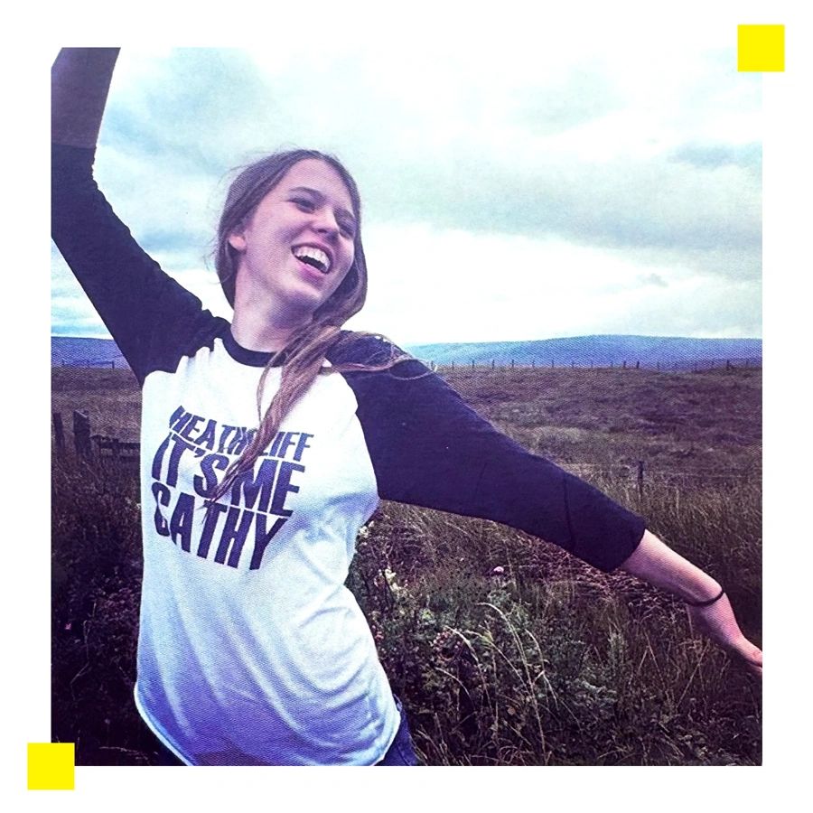 Happy woman dancing outdoors with open arms.