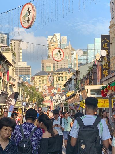 Crowds of people strollingtheclean and fragrant streets of Chinatown,Singapore. 