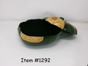 A green and beige turtle-shaped container with a removable lid.