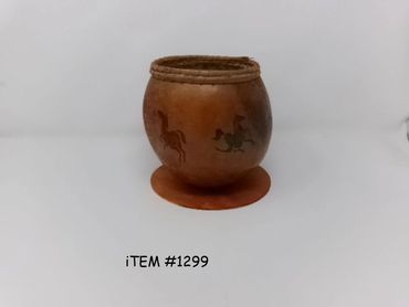 Handcrafted pot with horse designs on a white background.